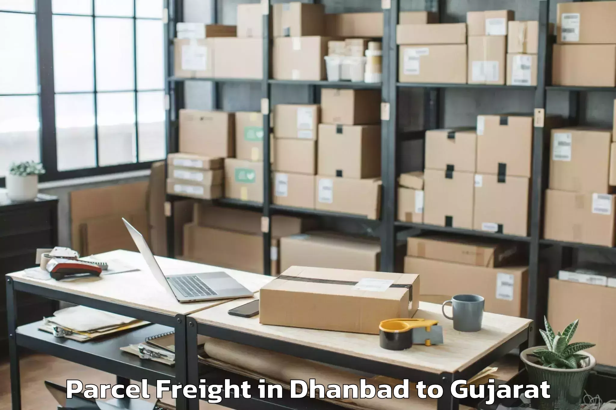 Leading Dhanbad to Gujarat University Of Transpla Parcel Freight Provider